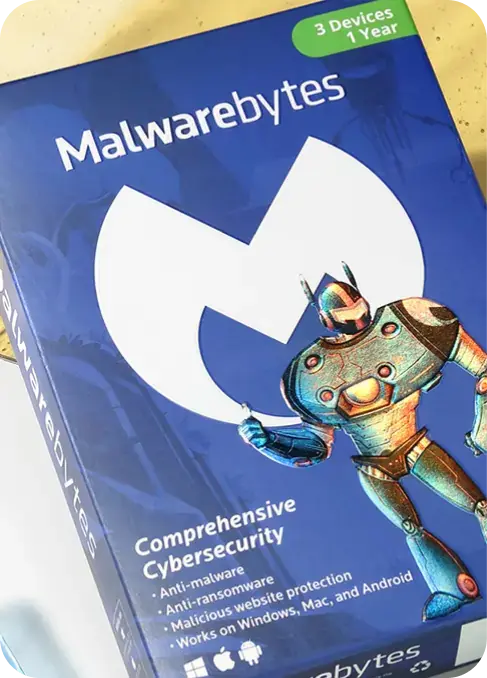 A Malwarebytes software box featuring a robot character on the front. The box highlights key features such as comprehensive cybersecurity, anti-malware, anti-ransomware, malicious website protection, and compatibility with Windows, Mac, and Android. It also mentions coverage for 3 devices for 1 year.